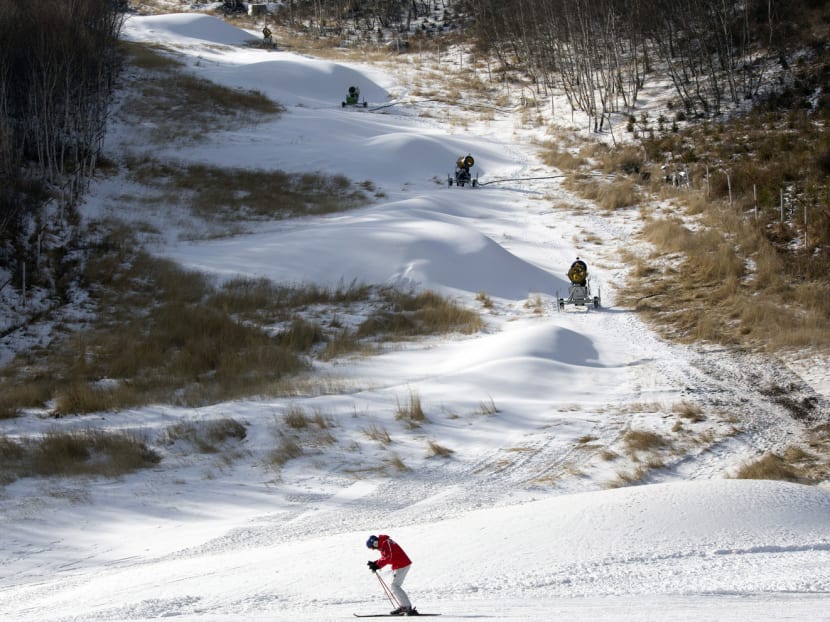 A skier passing by snow machines on the slopes of Chongli ski resort in Hebei. While winter sports are relatively new to China, it has been making up for lost time with 12 golds in skating and freestyle skiing. Photo: AP