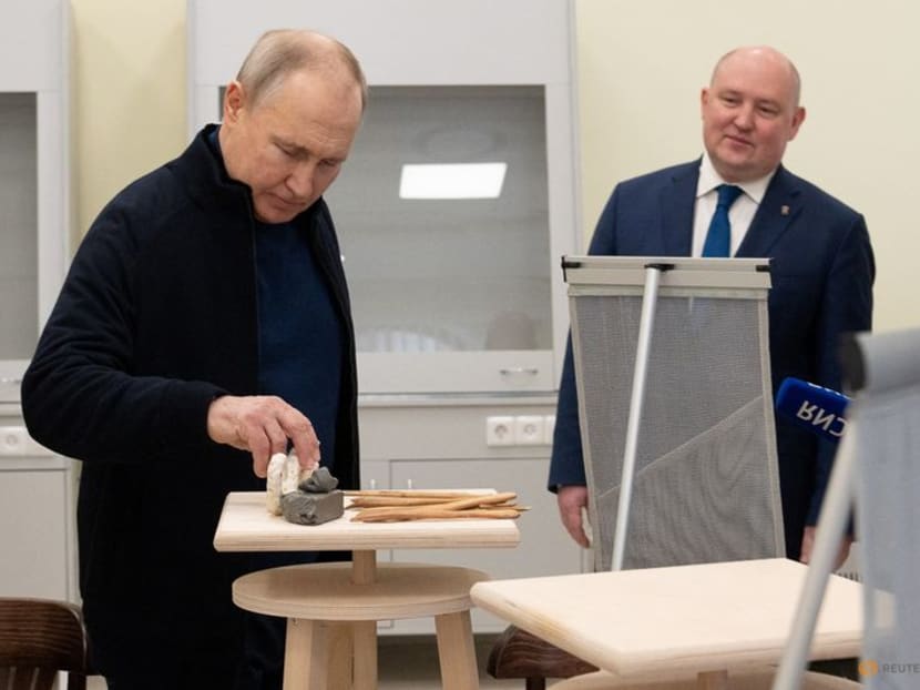 Russian President Vladimir Putin, accompanied by Governor of Sevastopol Mikhail Razvozhayev, visits a children's arts and aesthetic centre in Sevastopol, Crimea on March 18, 2023.