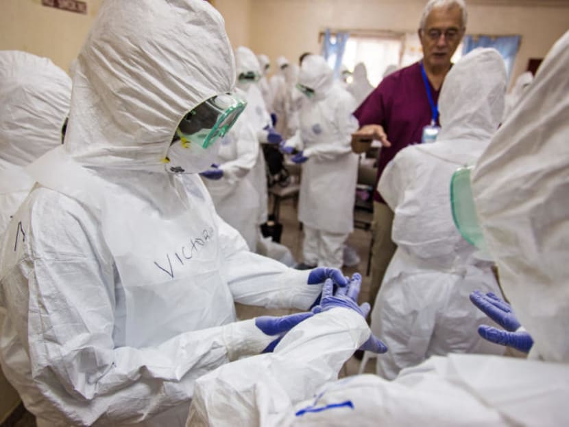 A World Health Organization, WHO, worker, right rear, trains nurses to use Ebola protective gear in Freetown, Sierra Leone, Thursday, Sept 18, 2014. Ebola still has no definite cure. Photo: AP