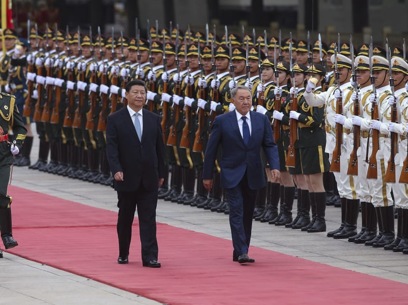 Chinese President Xi Jinping, seen here with Kazakhstan President Nursultan Nazarbayev as they view an honour guard in Beijing on Monday, is expected to announce a sweeping overhaul of the military. Photo: AP