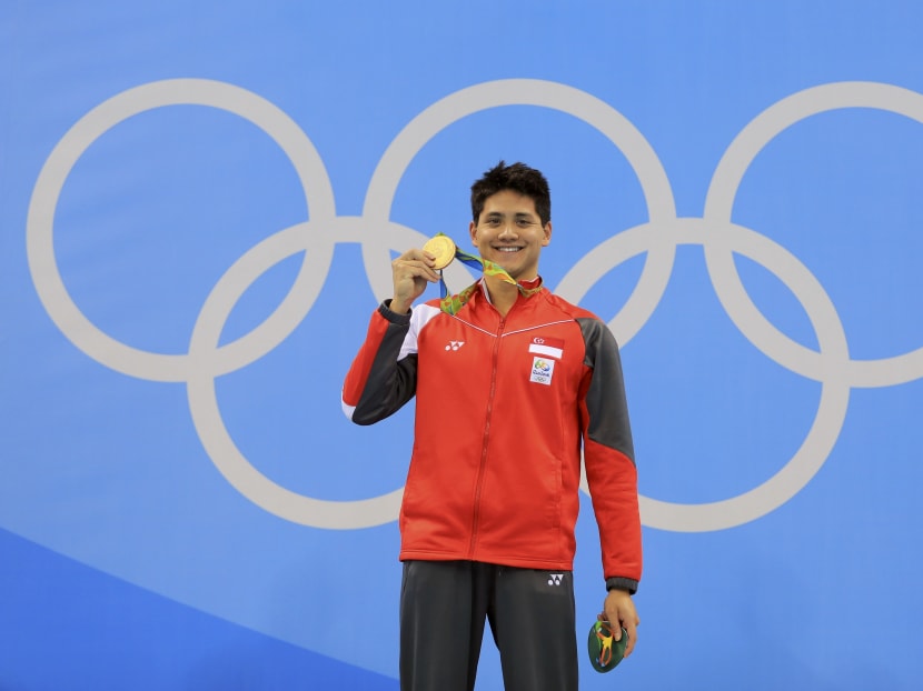 Joseph Schooling holding up his Olympic Gold medal. Photo: Reuters