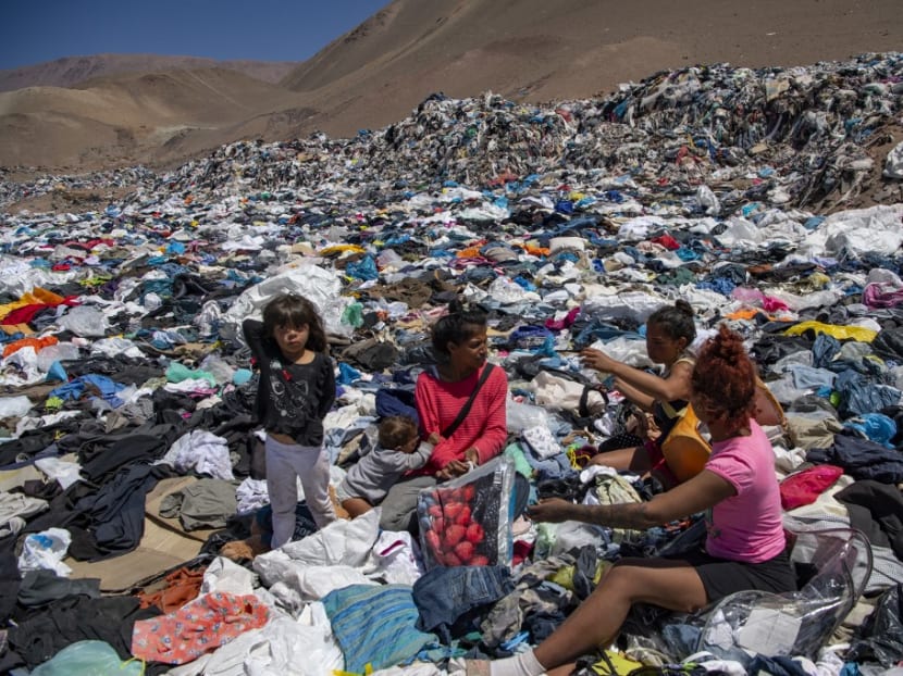 Women search for used clothes amid tons discarded in the Atacama desert, in Alto Hospicio, Iquique, Chile, on Sept 26, 2021. Women search for used clothes amid tons discarded in the Atacama desert, in Alto Hospicio, Iquique, Chile, on Sept 26, 2021.
