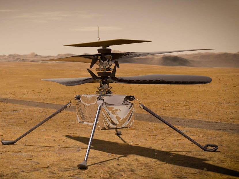 This photo obtained on March 23, 2021 shows an illustration of Nasa's Ingenuity Mars helicopter standing on the Red Planet's surface as Nasa's Perseverance rover (partially visible on the left) rolls away.