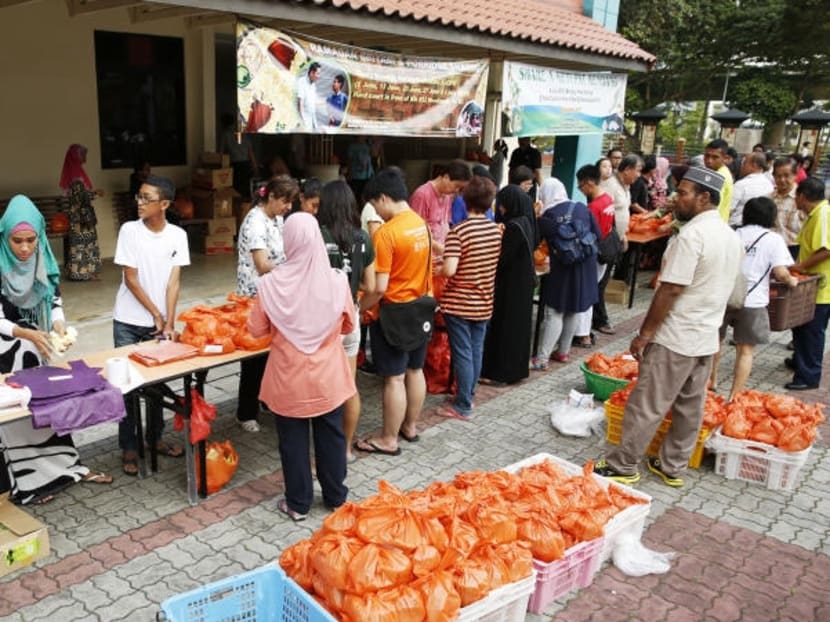 Organisers and volunteers packing the food to be distributed to the residents at a community outreach programme in 2016. More opportunities for volunteerism will come in the form of SG Cares, to be launched by the second half of this year. TODAY file photo