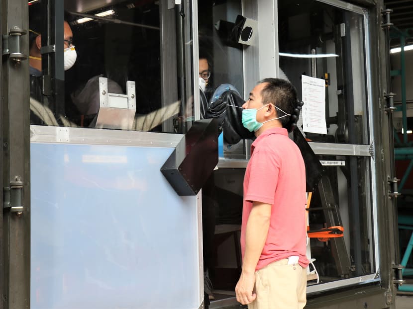 A migrant worker undergoing a Covid-19 swab test at the new mobile swab station. A migrant worker undergoing a Covid-19 swab test at the new mobile swab station.