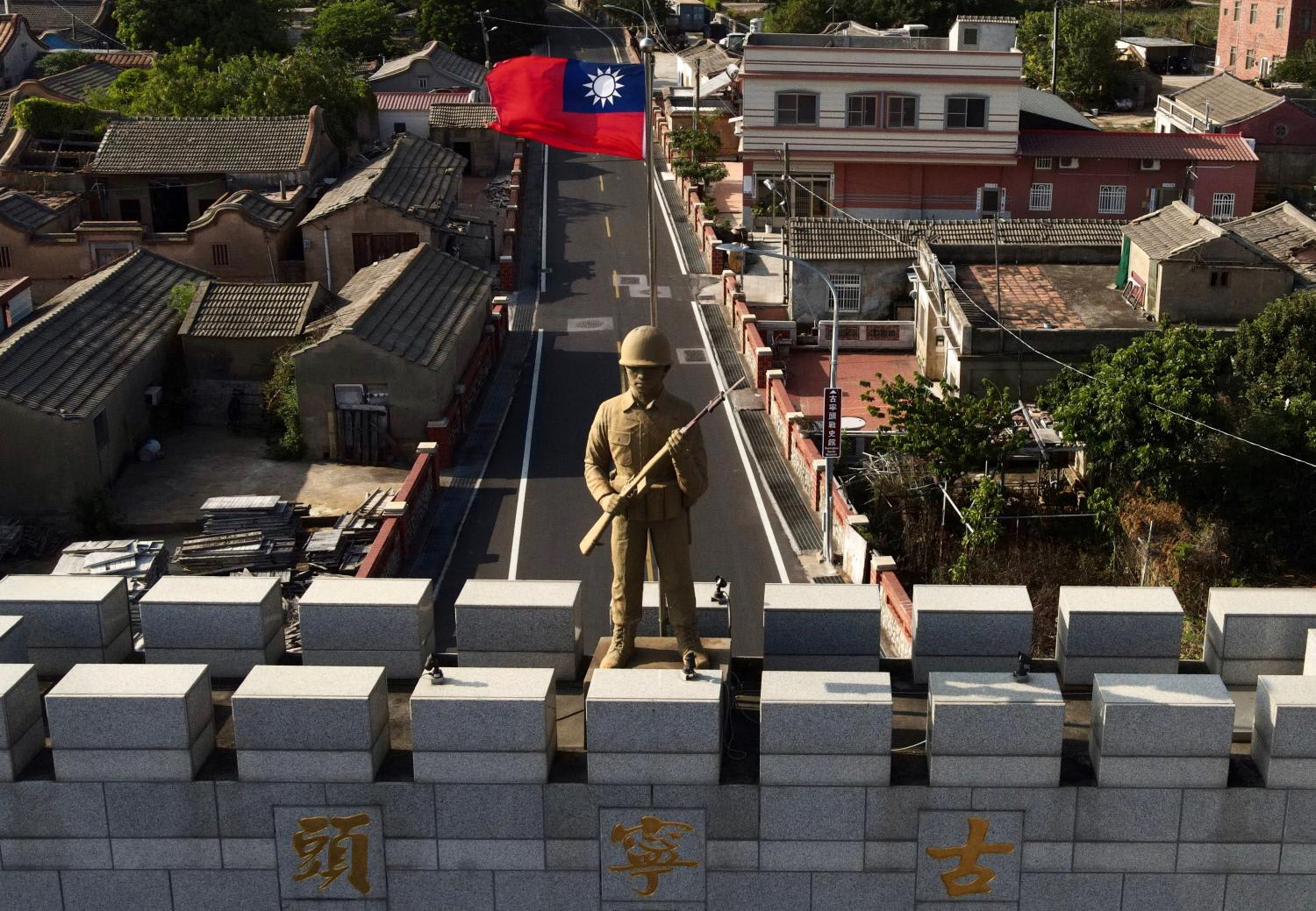 A military statue and Taiwanese flag on top of an arch built in remembrance of the Battle of Guningtou in 1949 at Taiwan's Kinmen islands, which lie just 3.2km from the mainland China coast in the Taiwan Strait.
