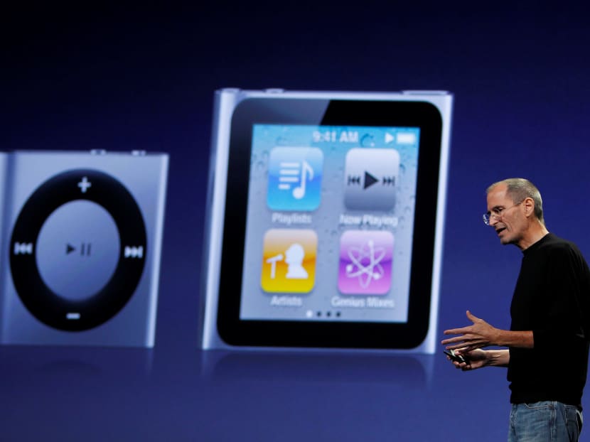 Apple Chief Executive Steve Jobs speaks on stage with images of the iPod Shuffle (L) and iPod Nano (R) projected on screen at Apple's music-themed September media event in San Francisco, California September 1, 2010. Photo: Reuters