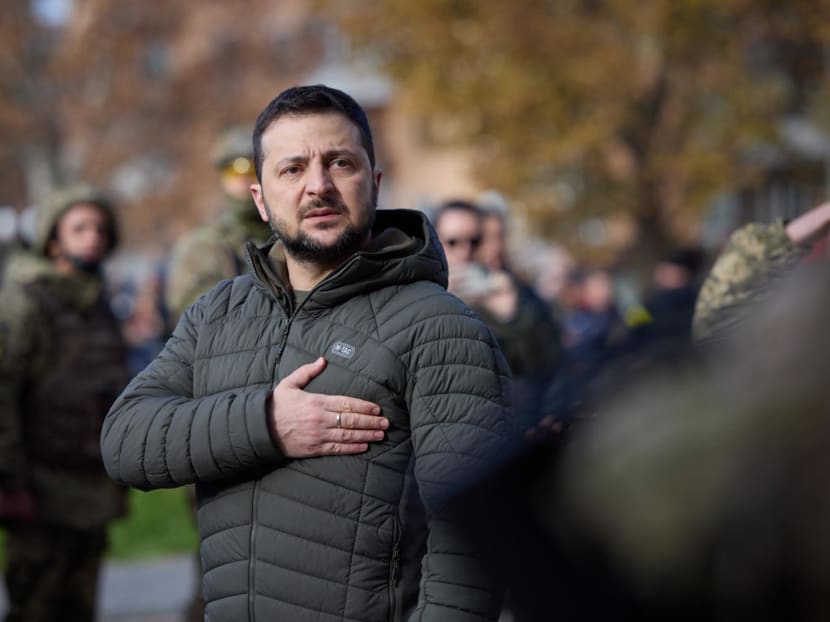 Handout photograph by the Ukrainian Presidential press service on Nov 14, 2022, shows Ukrainian President Volodymyr Zelensky taking part in the flag laying ceremony during his visit to the newly liberated city of Kherson, following the retreat of Russian forces from the strategic hub. Handout photograph by the Ukrainian Presidential press service on Nov 14, 2022, shows Ukrainian President Volodymyr Zelensky taking part in the flag laying ceremony during his visit to the newly liberated city of Kherson, following the retreat of Russian forces from the strategic hub.