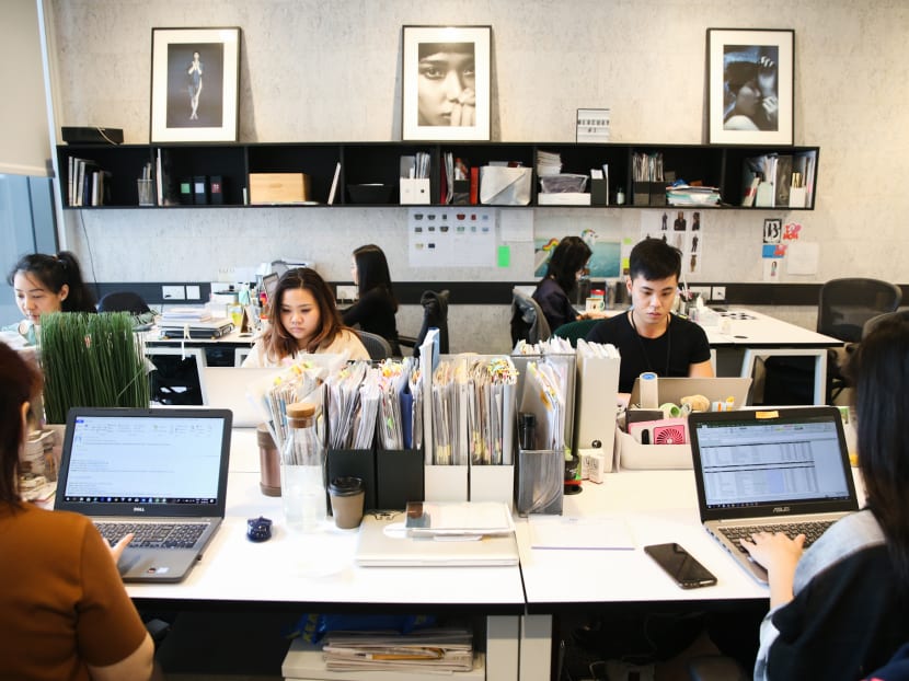 Mercury PR staff are seen working in their workspace at co-working space - The Work Project at OUE Downtown.