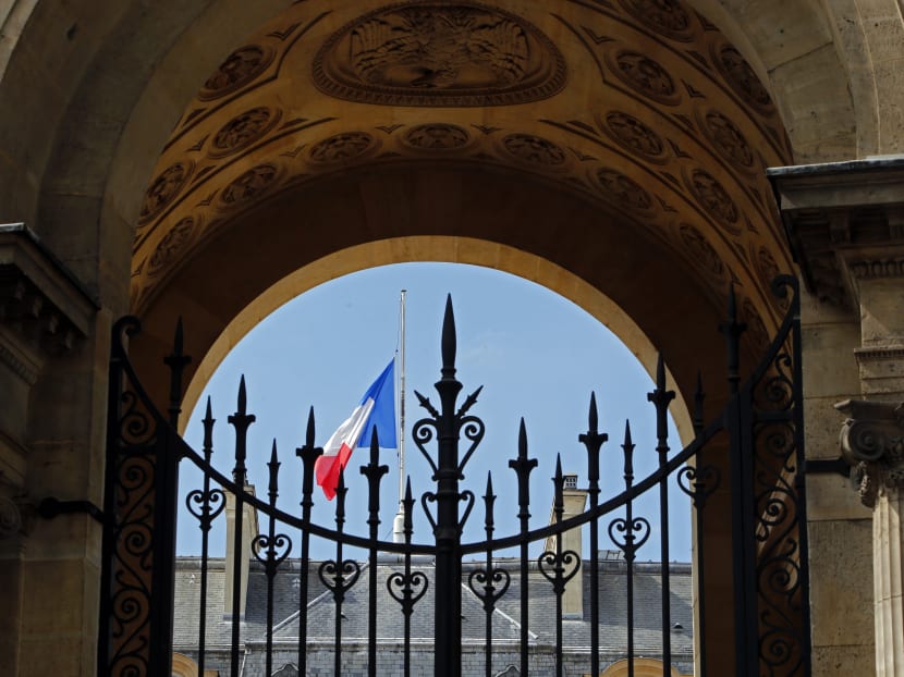 A half staff French flag flies at the Elysee Palace in Paris, France, on July 28, 2014 in a show of respect for the Air Algerie flight crash, that killed all 118 people onboard including 54 French citizens. Photo: AP