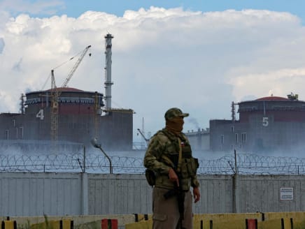 A serviceman with a Russian flag on his uniform stands guard near the Zaporizhzhia Nuclear Power Plant in the course of Ukraine-Russia conflict outside the Russian-controlled city of Enerhodar in the Zaporizhzhia region, Ukraine Aug 4, 2022.