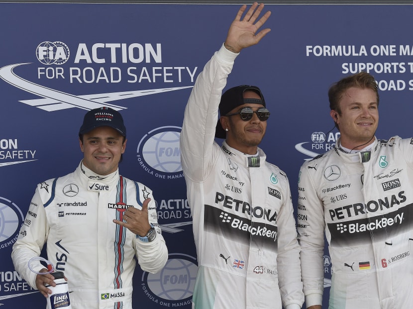 Williams driver Felipe Massa of Brazil, left, British Mercedes driver Lewis Hamilton, center, and German Mercedes driver Nico Rosberg celebrate after the qualyfying for the British Formula One Grand Prix at Silverstone circuit, Silverstone, England, Saturday, July 4, 2015. Photo: AP