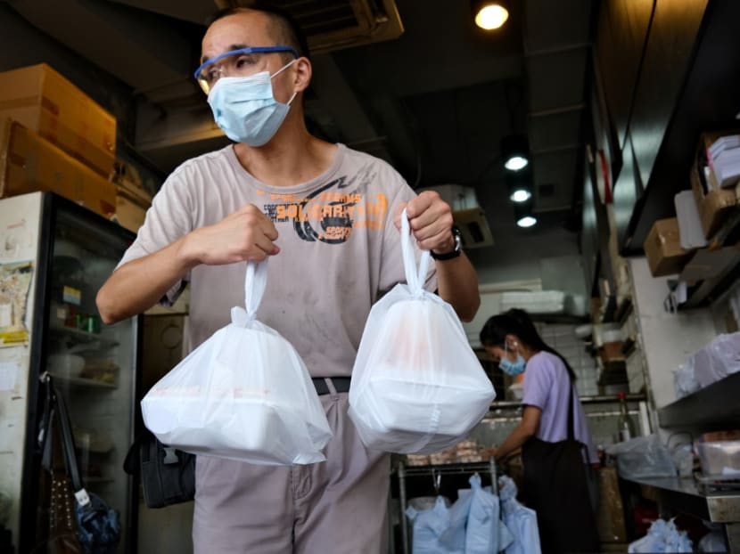 A man carries bags containing takeaway meals in Hong Kong on July 29, 2020.