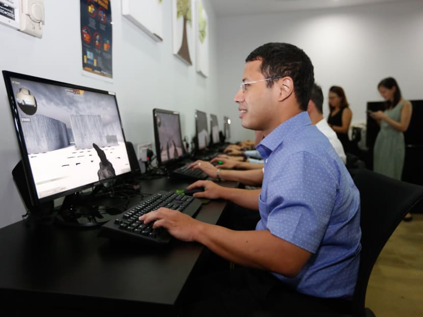 Minister for Social and Family Development Desmond Lee trying out a game of Counter Strike to understand how Touch counsellors use it to connect with youths through gameplay, and to help youths be aware of how to regulate their emotions in stressful situations.