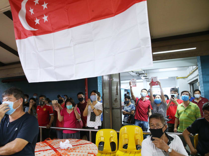 Residents and onlookers at Block 964, Jurong West Street 91 where Progress Singapore Party was doing its walkabout on July 8, 2020.