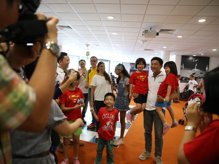Speaker of Parliament Tan Chuan-Jin posing with children attending the Dads’ Day Out carnival at the Singapore Sports Hub's OCBC Square on Sunday (June 17).
