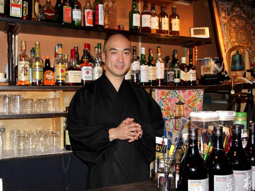 Buddhist monk Yoshinobu Fujioka poses at a monk-run bar in Tokyo on March 28, 2017.  Source: Kyodo