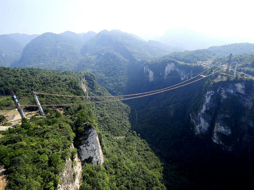 A glass bridge under construction over a canyon in Zhangjiajie National Park, Hunan province. A major issue the State Council reform plan is trying to tackle is coming up with a clear definition of what qualifies as a national park. Photo: Reuters