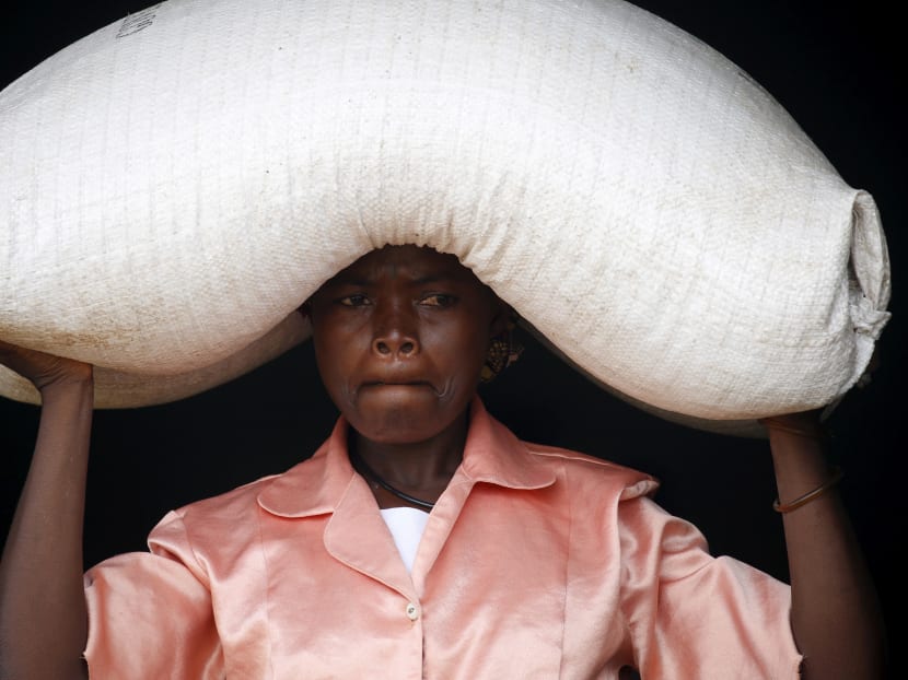 A woman in Malawi with food aid distributed by the United Nations World Food Progamme. The African nation paid US$5 million for a climate risk insurance, but when a drought hit last year, the policy did not pay out, according to a non-governmental organisation. Photo: Reuters