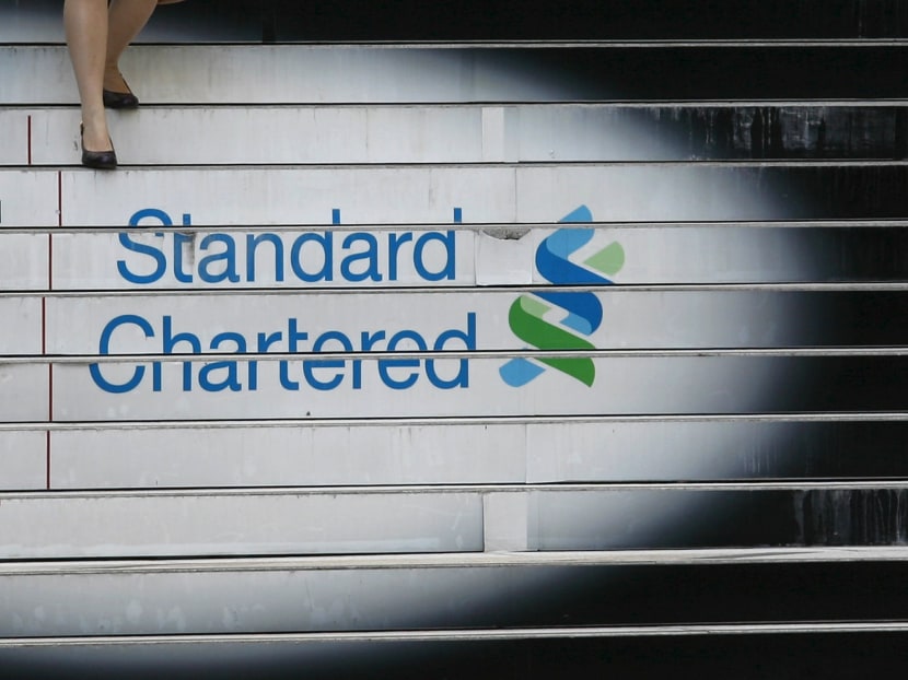 A woman walks down the stairs of the Standard Chartered headquarters in Hong Kong in this file photo. Photo: Reuters