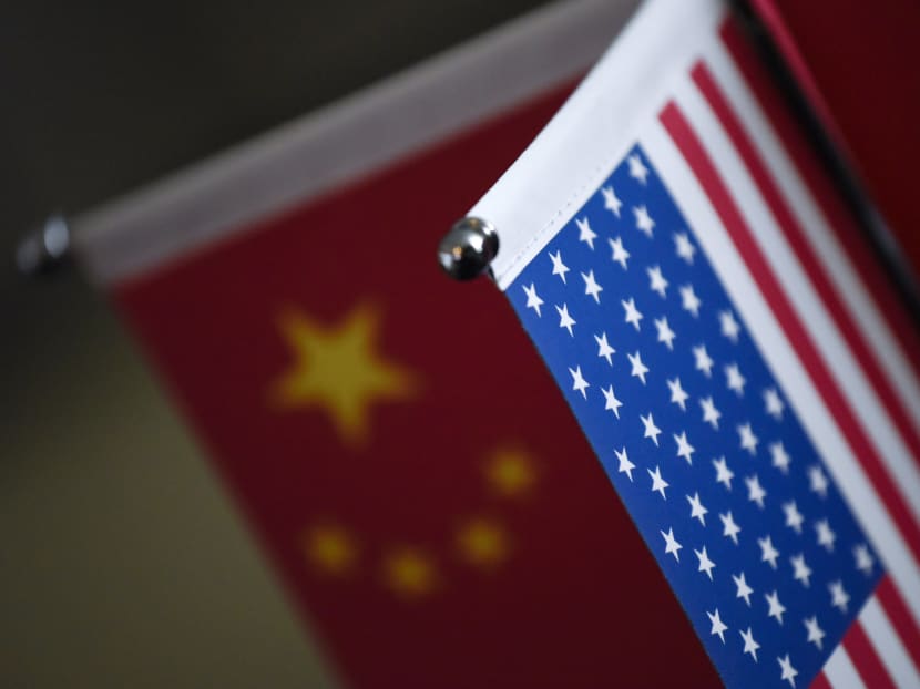 Chinese flags and American flags are displayed in a company in Beijing. China says it will temporarily exempt foreign companies from paying tax on their earnings, a bid to keep American businesses from taking their profits out of China following Washington’s overhaul of the United States tax code. Photo: AFP