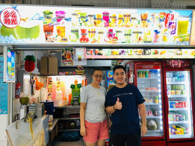 Mr Darren Teo of 51 Noodle House and the fruit juice vendor whom he has helped, by offering her drinks as an option for his customers, in an undated photograph.
