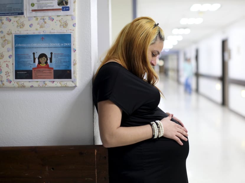 Jannelissa Santana, who is 37 weeks pregnant, leans on a wall, next to a flyer explaining how to prevent Zika, Dengue and Chikungunya viruses at a public hospital in San Juan, Feb 3, 2016. Photo: Reuters