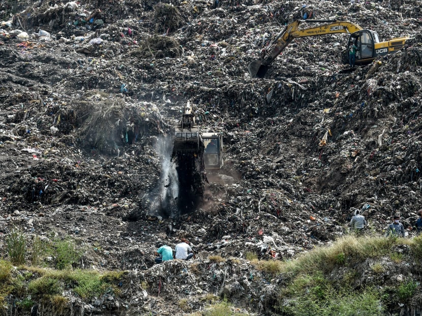 Rescue workers conduct a search operation on the Pirana landfill after Neha Vasava, 12, got buried under a mass of trash that fell while she was collecting discarded toys on the garbage mountain with her friend Anil Marwadi, 6, who got rescued, on the outskirts of Ahmedabad on Sept 27, 2020.