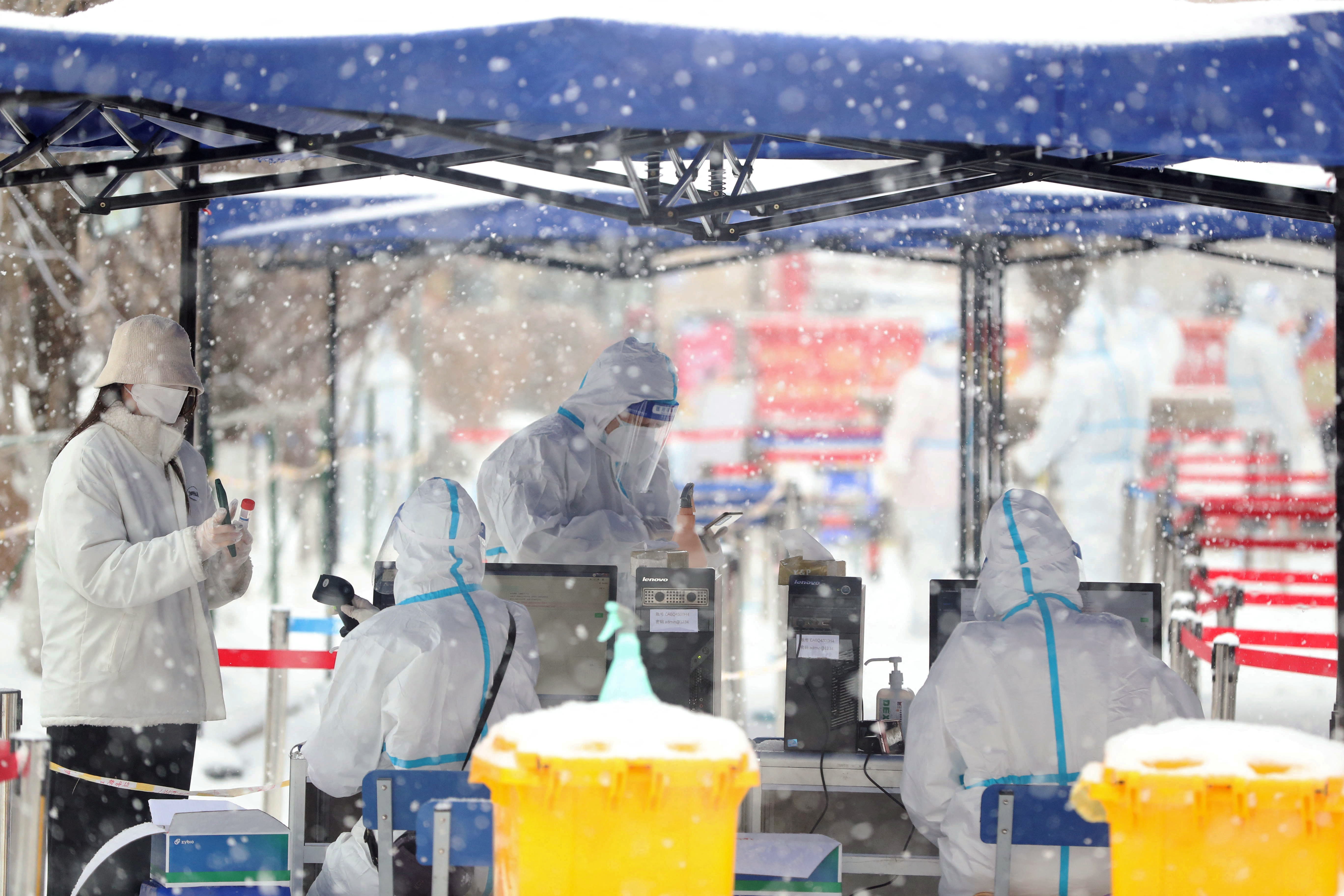 A resident prepares to get tested amid the snow at a nucleic acid testing site, following the Covid-19 outbreak in Changchun, Jilin province, China on March 15, 2022. 
