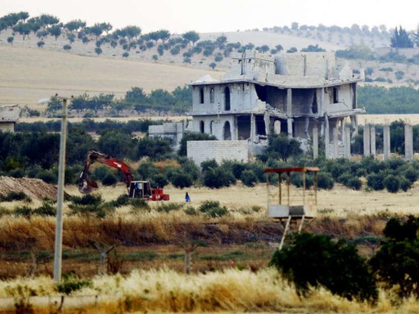 An excavator digging trenches in the IS-held Syrian town of Jarablus. The area is part of the Manbij pocket, a 90km strip that is the jihadi group’s last crossing zone into Turkey. Photo: Reuters