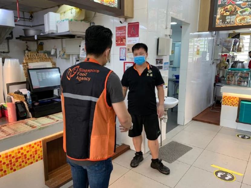 An enforcement officer doing an inspection at a coffee shop in Bedok North. Mr Masagos Zulkifli, Minister of the Environment and Water Resources, said that from April 8, 2020 onwards, the authorities will not hesitate to issue stern warnings that will lead to fines for people who still continue to gather in public.