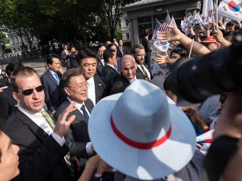 South Korean President Moon Jae-in greeting supporters near Blair House where he is staying across the street from the White House in Washington, DC, on June 28, 2017. Moon will meet with US President Donald Trump on June 29-30. Photo: AFP