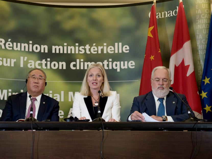 From left: China’s representative on climate change Xie Zhenhua, Canadian Environment Minister Catherine McKenna and EU Commissioner for Climate Change and Energy Miguel Arias Canete after a meeting on Saturday in Montreal. Ms McKenna said they are pleased the US continues to engage despite its stance. Photo: AFP