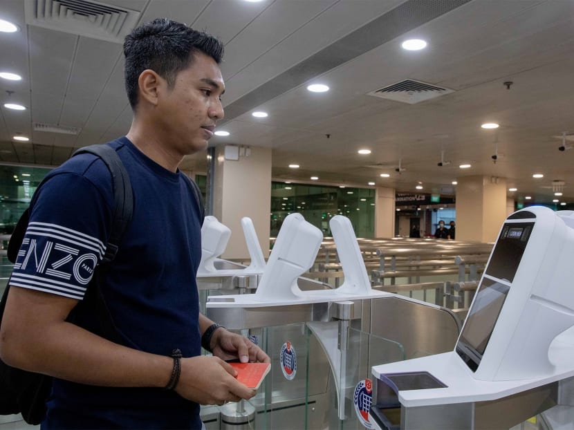 Mr Mohammad Shahrin Mohd Ali (pictured), an Immigration and Checkpoints Authority officer, demonstrating how to use the iris and facial scan at the automated immigration lanes of Woodlands checkpoint.