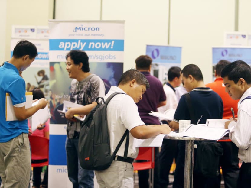 Job applicants at a career fair in April 2017. Manpower Minister Lim Swee Say said some companies have "pre-conceived ideas" that local professionals, managers and executives are "either unable or unwilling to do the job". TODAY File Photo