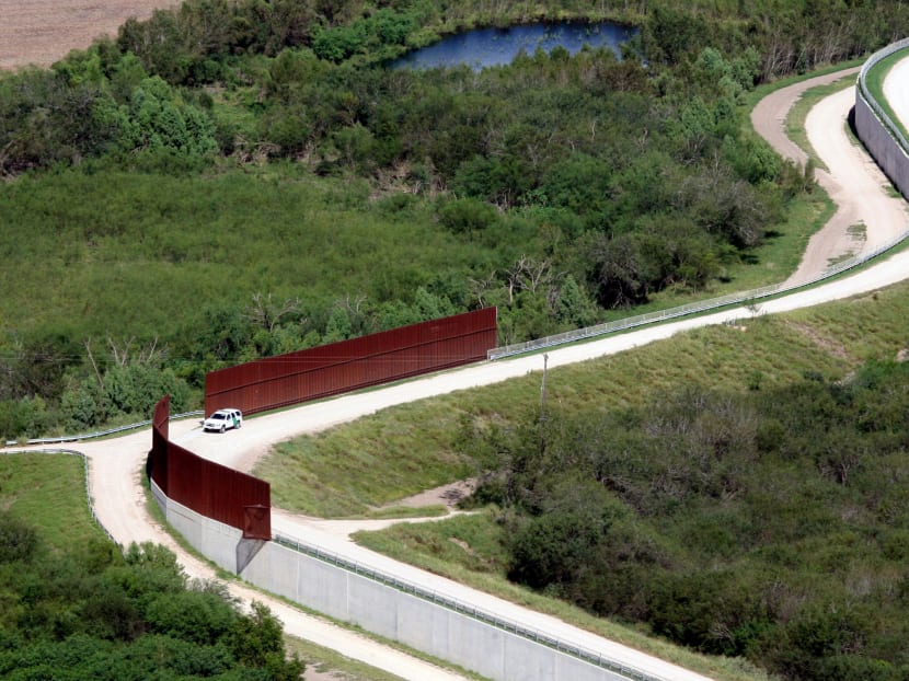 In this Nov 16, 2015, aerial file photo, a US border patrol vehicle appears near the border wall near Abram, Texas, from a US Customs and Border Protection helicopter. Photo: The Monitor via AP