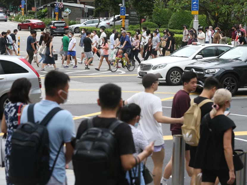People at a traffic junction on Orchard Road in April 2022.