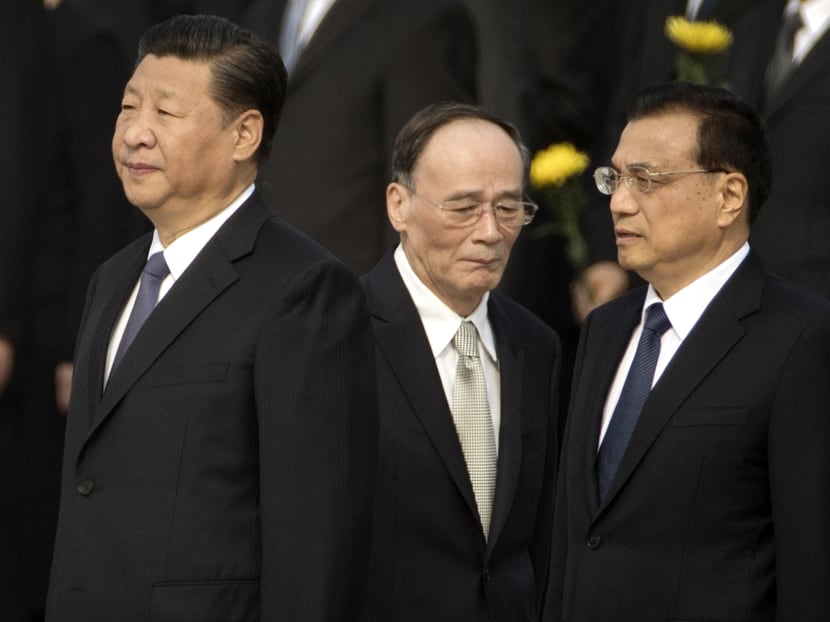 Chinese President Xi Jinping, left, Politburo Standing Committee member Wang Qishan, centre, and Chinese Premier Li Keqiang attend a ceremony marking Martyrs' Day at Tiananmen Square in Beijing. Photo: AP