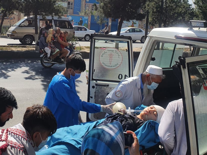 Relatives and medical staff shift a wounded girl from an ambulance outside a hospital in Kabul on Sept 30, 2022, following a blast at a learning centre in the Dasht-e-Barchi area of Afghanistan's capital. 