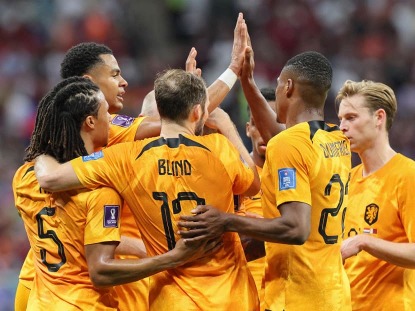 Netherlands' forward Cody Gakpo (second left) celebrates scoring the opening goal with his teammates during the Qatar 2022 World Cup Group A football match between the Netherlands and Qatar at the Al-Bayt Stadium in Al Khor on Nov 29, 2022.