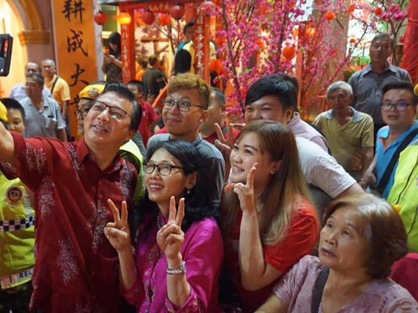 MCA President Liow Tiong Lai (holding phone) with supporters at a recent Chinese New Year event. MCA’s performance in the election is crucial as it relates to the survival of the party. Photo: Facebook / MCA