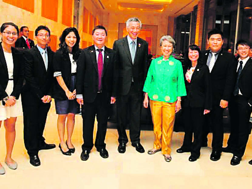 Prime Minister Lee Hsien Loong (fifth from left) and his wife Ho Ching with delegates from the Singapore ‘Voices Of The Future’ delegation in Bali, Indonesia yesterday. Photo: MCI