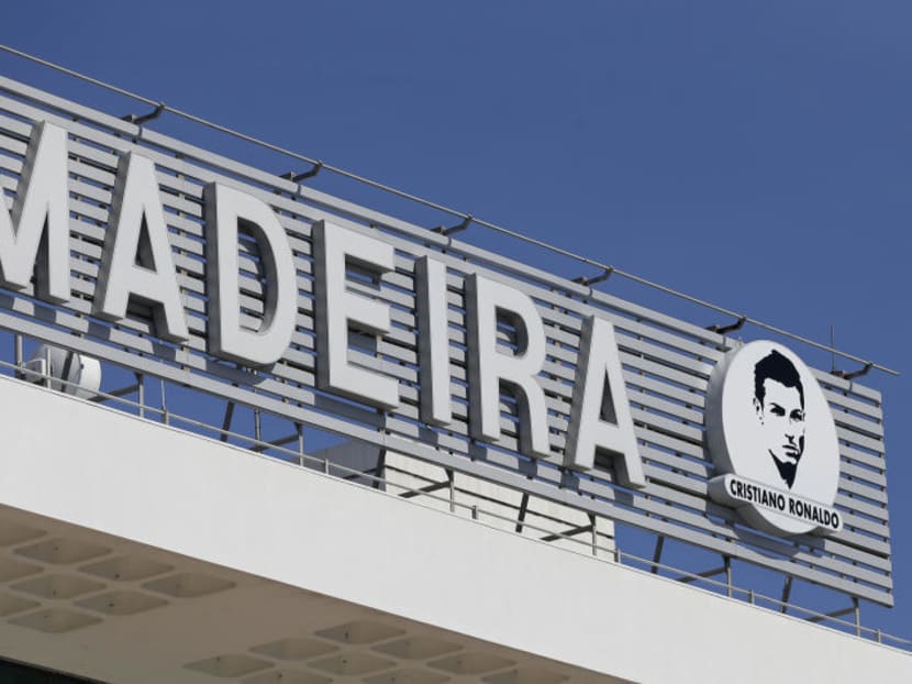 An image of Cristiano Ronaldo sits next to the Madeira airport sign at the Madeira international airport outside Funchal, the capital of Madeira island, Portugal, Wednesday March 29, 2017. Madeira International Airport has be renamed after local soccer star Cristiano Ronaldo on Wednesday during a ceremony. AP Photo