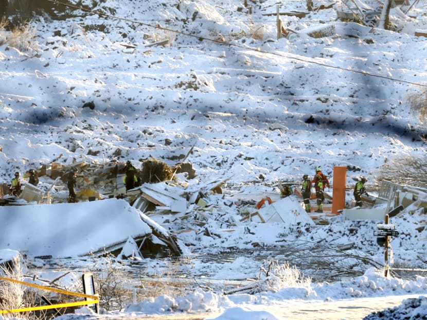 Rescue workers with a dog search the area on Jan 3, 2021 following the landslide that hit a residential area in Ask in Gjerdrum during Christmas.