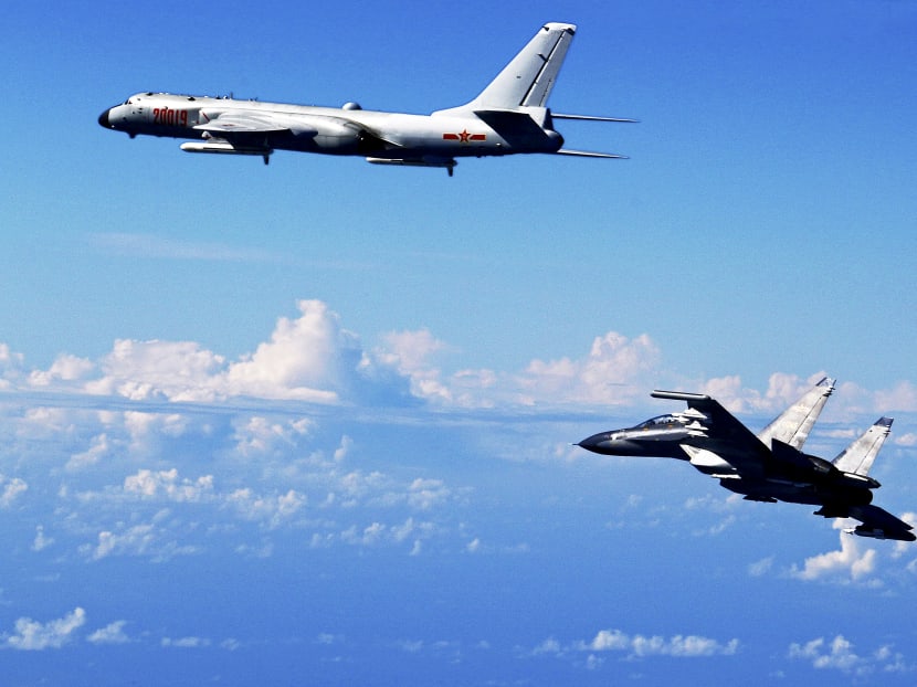 A Chinese People’s Liberation Army Air Force Su-30 fighter (right) and a H-6K bomber taking part in a drill near the East China Sea in September. AP file photo