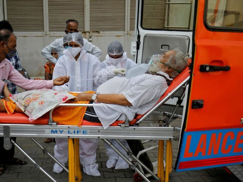 A patient wearing an oxygen mask is wheeled inside a Covid-19 hospital for treatment in Ahmedabad, India on April 26, 2021.