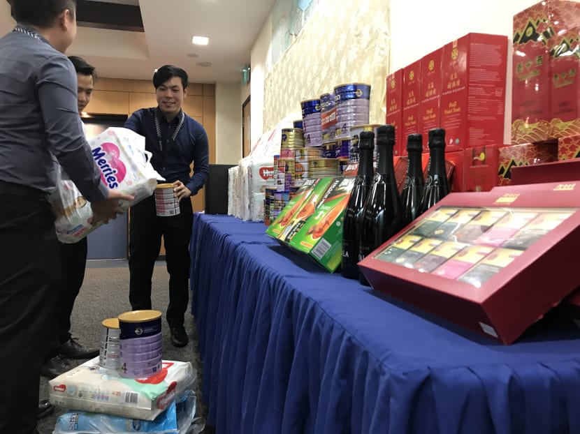 The items police seized from the suspect included more than 20 cans of milk powder, 15 pre-paid cards, and eight electronic devices.