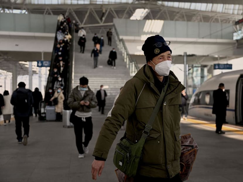 This picture taken on Jan 5, 2023 shows a man wearing a face mask amid the Covid-19 pandemic arriving at a train station in Bengbu, east China's Anhui Province. Exhausted doctors working overtime, tests and treatments nowhere to be found, and under-resourced clinics inundated with patients —  in Anhui, one of east China's poorest provinces, Covid hit hard.
