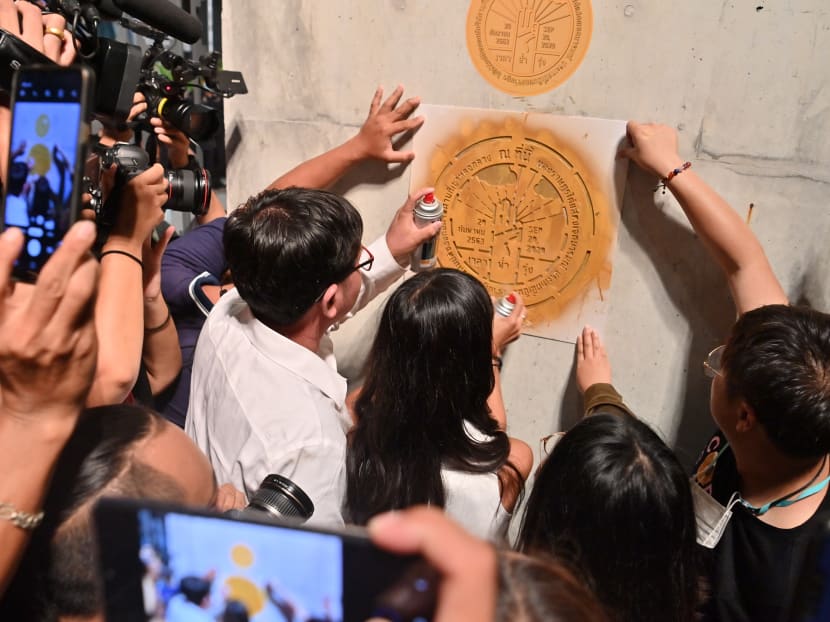 Anti-government protesters paints a marker symbolising the "People's Plaque" outside the closed main gate of Thailand's parliament during a pro-democracy rally in Bangkok on Sept 24. Anti-government protesters paints a marker symbolising the "People's Plaque" outside the closed main gate of Thailand's parliament during a pro-democracy rally in Bangkok on Sept 24.