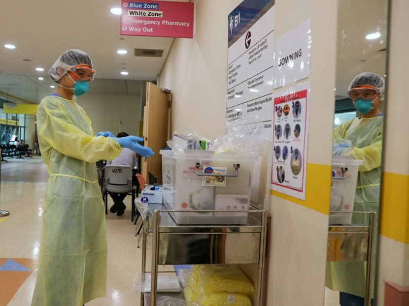 A staff member of Tan Tock Seng Hospital's emergency department putting on protective gear. A new study suggests that the measures taken to keep healthcare workers safe have successfully ensured that they do not get infected with the coronavirus.